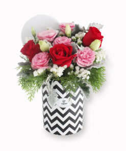 Elegant floral arrangement in round gift box